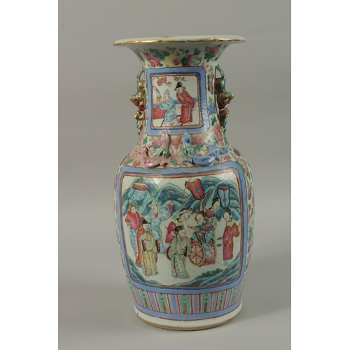 20 - A CHINESE FAMILLE ROSE PORCELAIN TWIN HANDLE VASE, with panels of figures, (af), 43cm high.