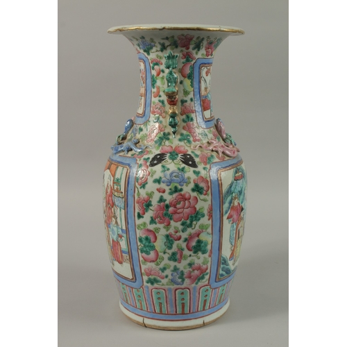 20 - A CHINESE FAMILLE ROSE PORCELAIN TWIN HANDLE VASE, with panels of figures, (af), 43cm high.