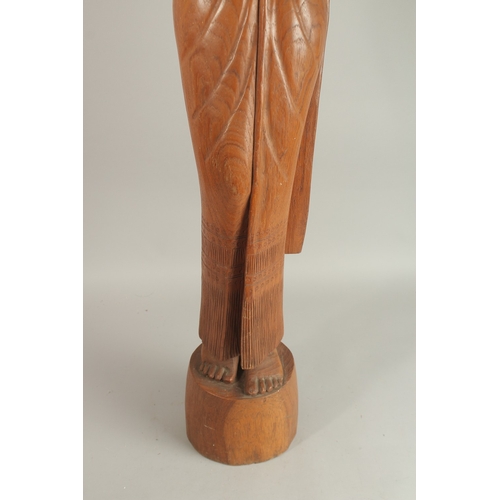 208 - A LARGE BALINESE FLOOR STANDING CARVED WOOD FIGURE, 115cm high.