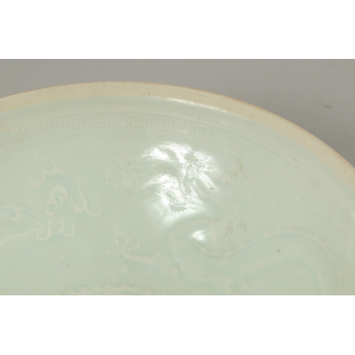 22 - A CHINESE CELADON GLAZE EGGSHELL PORCELAIN DRAGON BOWL, 19.5cm diameter.