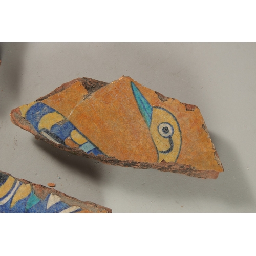 225 - THREE 17TH-18TH INDIAN TILE FRAGMENTS, with bird designs, largest 29cm wide, (3).