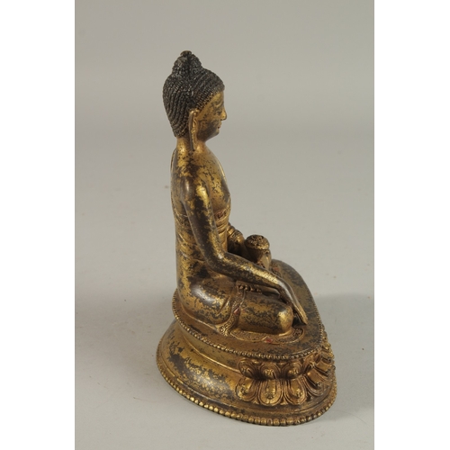 233 - A TIBETAN GILT BRONZE SEATED BUDDHA ON LOTUS BASE, 20cm high.