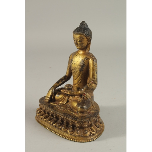 233 - A TIBETAN GILT BRONZE SEATED BUDDHA ON LOTUS BASE, 20cm high.