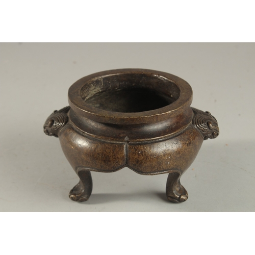 234 - A CHINESE BRONZE TRIPOD CENSER, with lion face handles, the base with character mark, 17cm wide (han... 