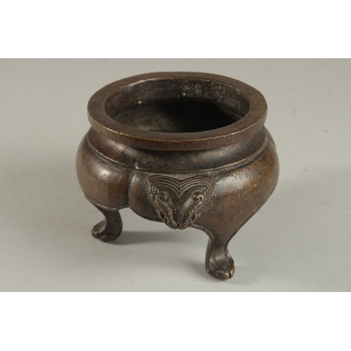 234 - A CHINESE BRONZE TRIPOD CENSER, with lion face handles, the base with character mark, 17cm wide (han... 