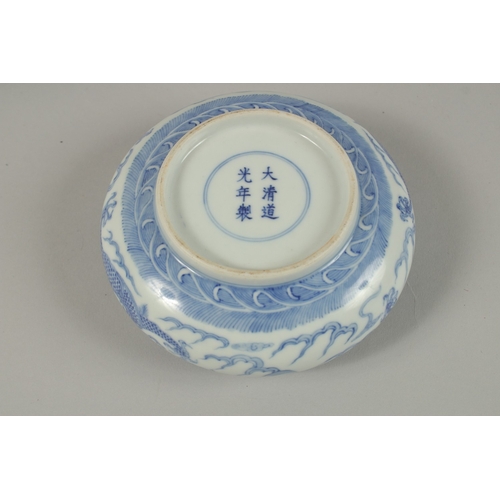 26 - A CHINESE BLUE AND WHITE PORCELAIN DRAGON BOWL, together with a pair of turquoise ground petal rim b... 