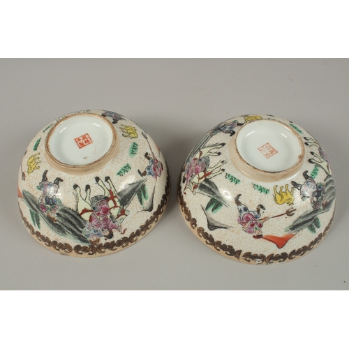 27 - A PAIR OF CHINESE PORCELAIN BOWLS, painted with figures on horseback, 15cm diameter.