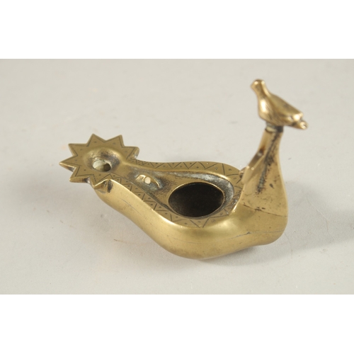 270 - A BRASS OIL LAMP WITH CROSS AND BIRD HANDLE, 10.5cm long.