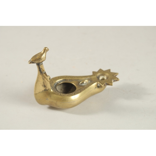 270 - A BRASS OIL LAMP WITH CROSS AND BIRD HANDLE, 10.5cm long.