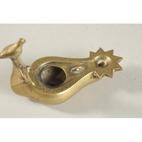 270 - A BRASS OIL LAMP WITH CROSS AND BIRD HANDLE, 10.5cm long.