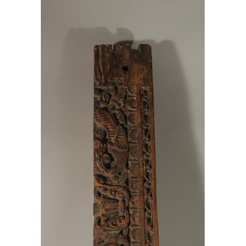 276 - A 16TH-17TH CENTURY INDIAN CARVED WOOD PANEL, with peacock and parrot designs, 136cm long.