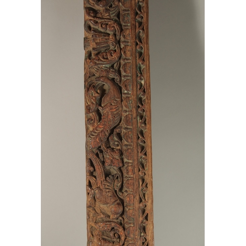 276 - A 16TH-17TH CENTURY INDIAN CARVED WOOD PANEL, with peacock and parrot designs, 136cm long.