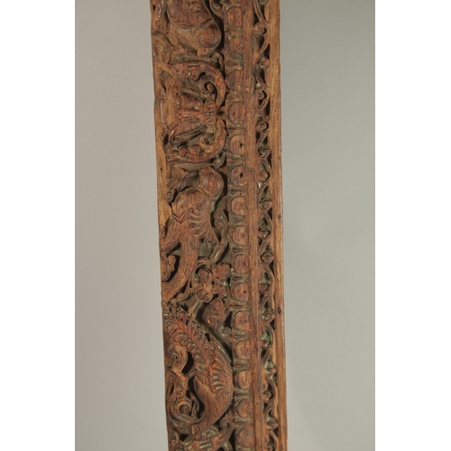 276 - A 16TH-17TH CENTURY INDIAN CARVED WOOD PANEL, with peacock and parrot designs, 136cm long.