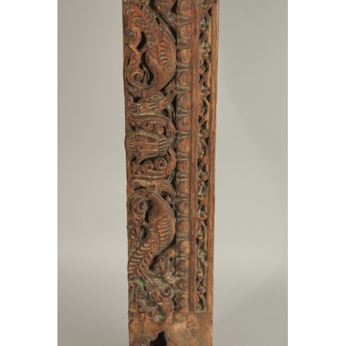 276 - A 16TH-17TH CENTURY INDIAN CARVED WOOD PANEL, with peacock and parrot designs, 136cm long.