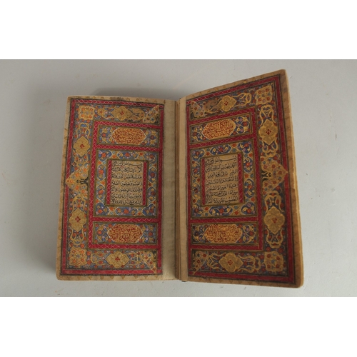 277 - A FINE 19TH CENTURY QAJAR POCKET SIZE QURAN, with original lacquered floral cover and finely gilded ... 