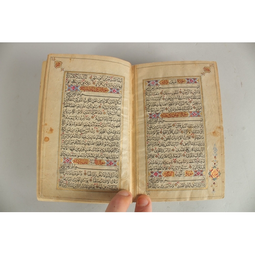 277 - A FINE 19TH CENTURY QAJAR POCKET SIZE QURAN, with original lacquered floral cover and finely gilded ... 