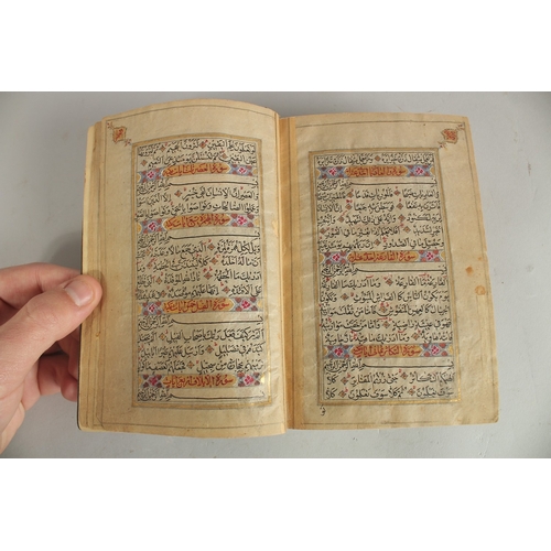 277 - A FINE 19TH CENTURY QAJAR POCKET SIZE QURAN, with original lacquered floral cover and finely gilded ... 