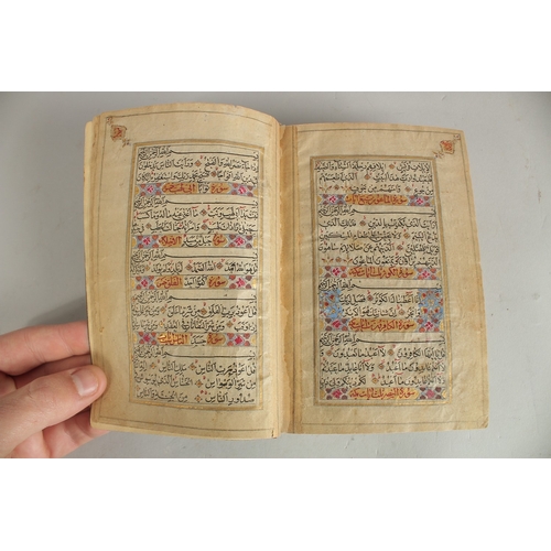 277 - A FINE 19TH CENTURY QAJAR POCKET SIZE QURAN, with original lacquered floral cover and finely gilded ... 