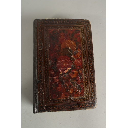 277 - A FINE 19TH CENTURY QAJAR POCKET SIZE QURAN, with original lacquered floral cover and finely gilded ... 