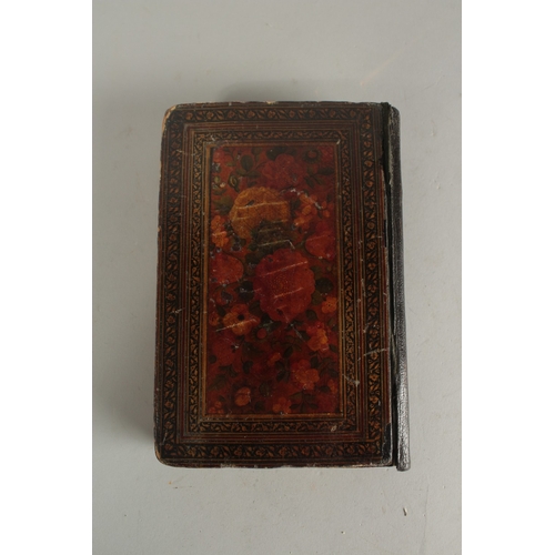 277 - A FINE 19TH CENTURY QAJAR POCKET SIZE QURAN, with original lacquered floral cover and finely gilded ... 