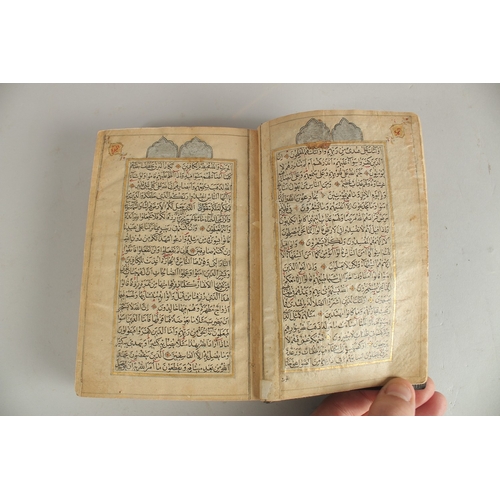 277 - A FINE 19TH CENTURY QAJAR POCKET SIZE QURAN, with original lacquered floral cover and finely gilded ... 