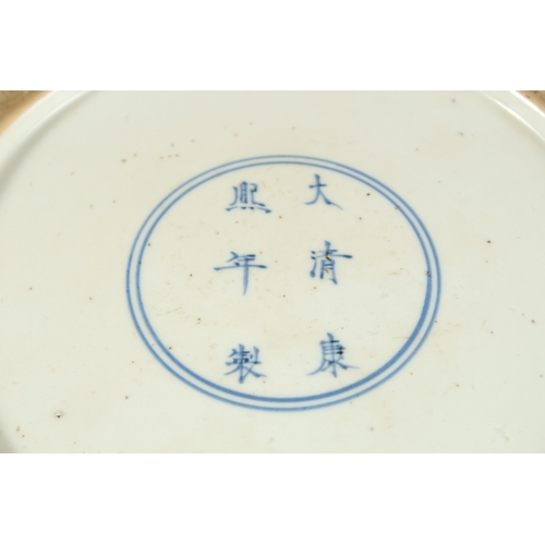 299 - A CHINESE FAMILLE VERTE PORCELAIN DISH, painted with figures in a courtyard, 27cm diameter.