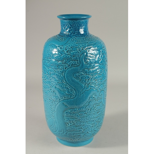 302 - A CHINESE TURQUOISE GLAZE PORCELAIN LANTERN VASE, carved with dragons and stylised clouds, 35cm high... 