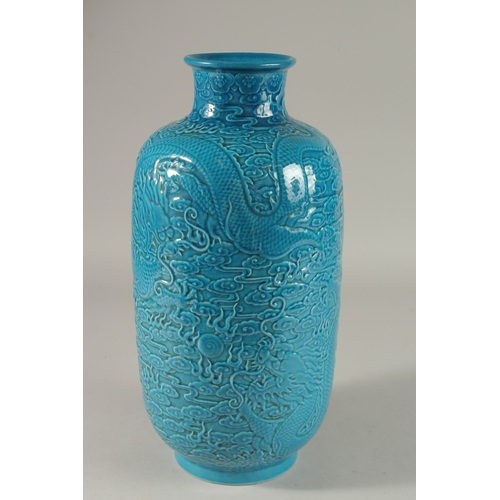 302 - A CHINESE TURQUOISE GLAZE PORCELAIN LANTERN VASE, carved with dragons and stylised clouds, 35cm high... 