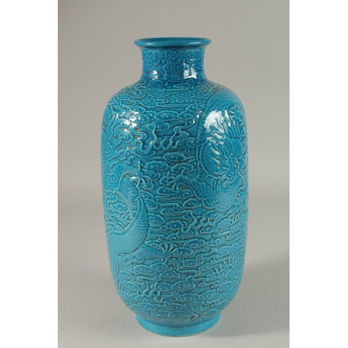 302 - A CHINESE TURQUOISE GLAZE PORCELAIN LANTERN VASE, carved with dragons and stylised clouds, 35cm high... 