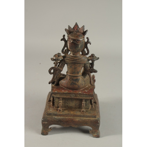 307 - A CHINESE BRONZE SEATED BUDDHA, raised on a square-form plinth with traces of gilding, 25cm high.