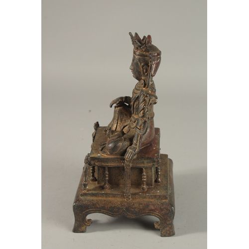 307 - A CHINESE BRONZE SEATED BUDDHA, raised on a square-form plinth with traces of gilding, 25cm high.