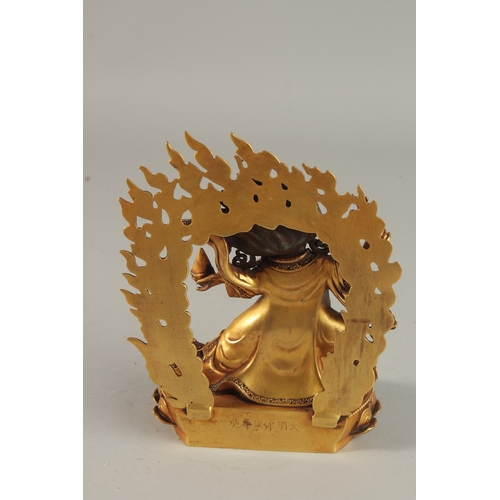 308 - A FINE TIBETAN GILDED ALLOY DEITY, with flaming halo, 18cm high.