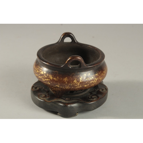 309 - A CHINESE GOLD SPLASH BRONZE TWIN HANDLE CENSER, on hardwood stand, with six-character mark to base,... 