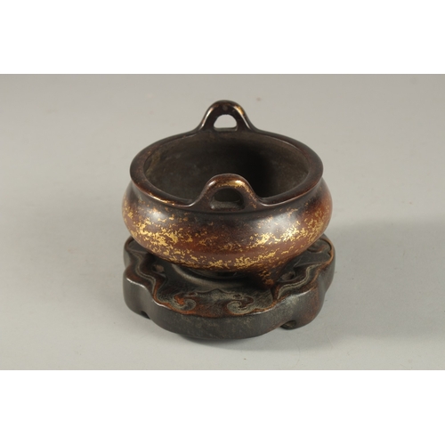 309 - A CHINESE GOLD SPLASH BRONZE TWIN HANDLE CENSER, on hardwood stand, with six-character mark to base,... 