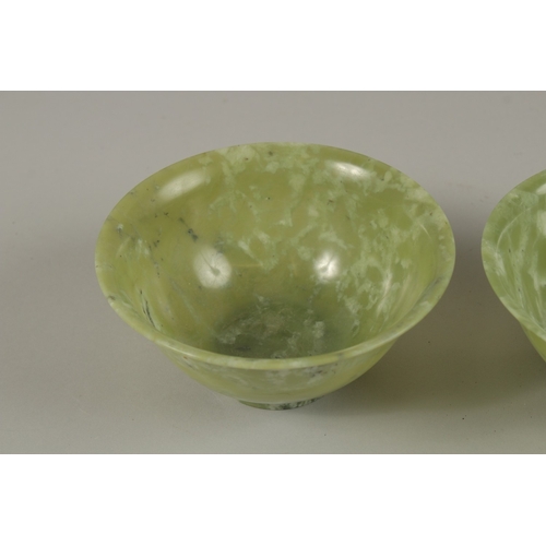 31 - A PAIR OF CHINESE JADE BOWLS, 13cm diameter.