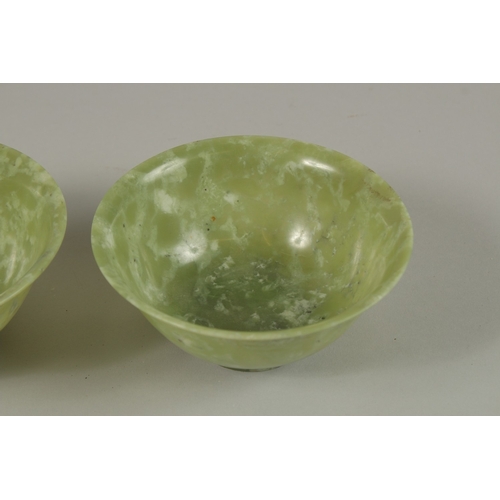 31 - A PAIR OF CHINESE JADE BOWLS, 13cm diameter.