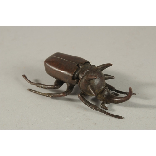 311 - A BRONZE OKIMONO OF A RHINOCEROS BEETLE.