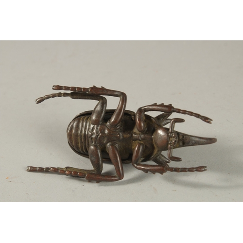 311 - A BRONZE OKIMONO OF A RHINOCEROS BEETLE.