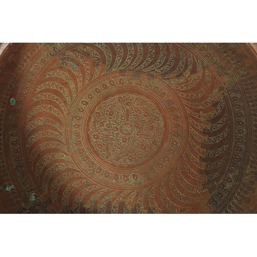 319 - A LARGE PERSIAN ENGRAVED COPPER BOWL, 41.5cm diameter, together with a Tibetan brass tray, (2).