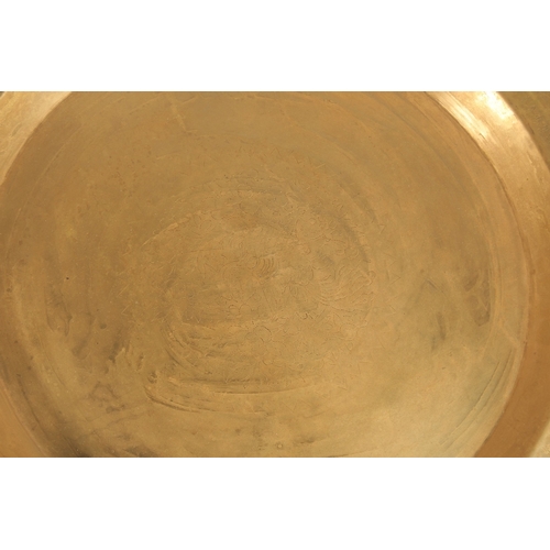 319 - A LARGE PERSIAN ENGRAVED COPPER BOWL, 41.5cm diameter, together with a Tibetan brass tray, (2).