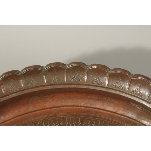 319 - A LARGE PERSIAN ENGRAVED COPPER BOWL, 41.5cm diameter, together with a Tibetan brass tray, (2).