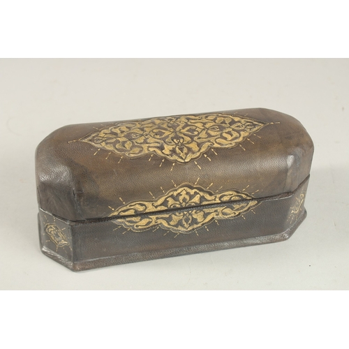 322 - A TURKISH LEATHER OVERLAID WOODEN PEN BOX, 22.5cm long.