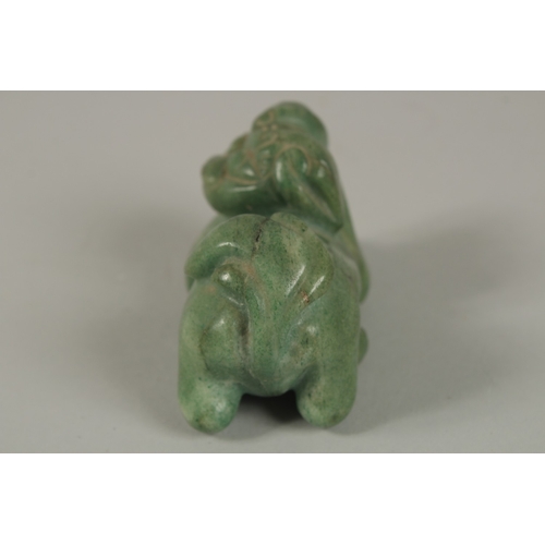 33 - A CHINESE CARVED GREEN HARDSTONE DOG OF FO, 8cm long.