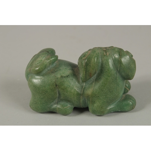 33 - A CHINESE CARVED GREEN HARDSTONE DOG OF FO, 8cm long.