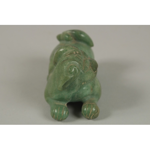 33 - A CHINESE CARVED GREEN HARDSTONE DOG OF FO, 8cm long.