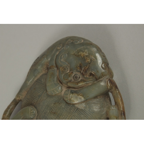 35 - A LARGE CHINESE CARVED JADE PEBBLE, with two mythical beasts, 15cm x 11cm.