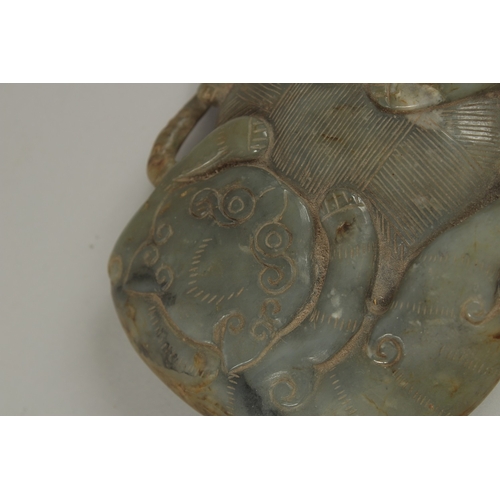 35 - A LARGE CHINESE CARVED JADE PEBBLE, with two mythical beasts, 15cm x 11cm.