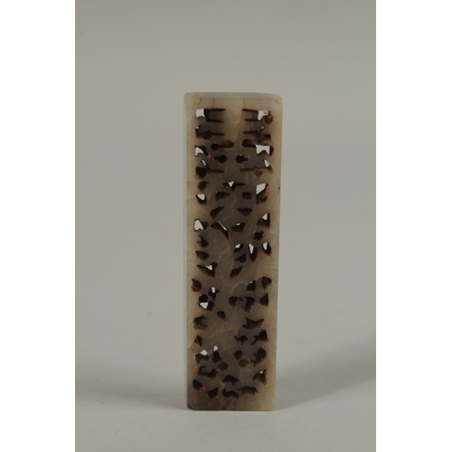 36 - A SMALL CHINESE CARVED AND PIERCED JADE SEAL, 7cm long.