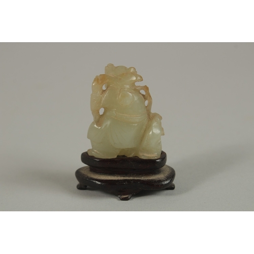 39 - A CHINESE MINIATURE JADE CARVING OF AN IMMORTAL WITH ANIMAL, on a wooden stand, jade 3.5cm high.