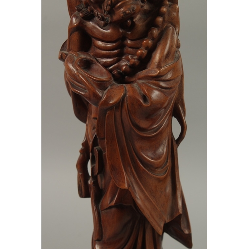 54 - A VERY FINE PAIR OF CHINESE CARVED HARDWOOD FIGURES, with inset bead eyes, 45cm high.